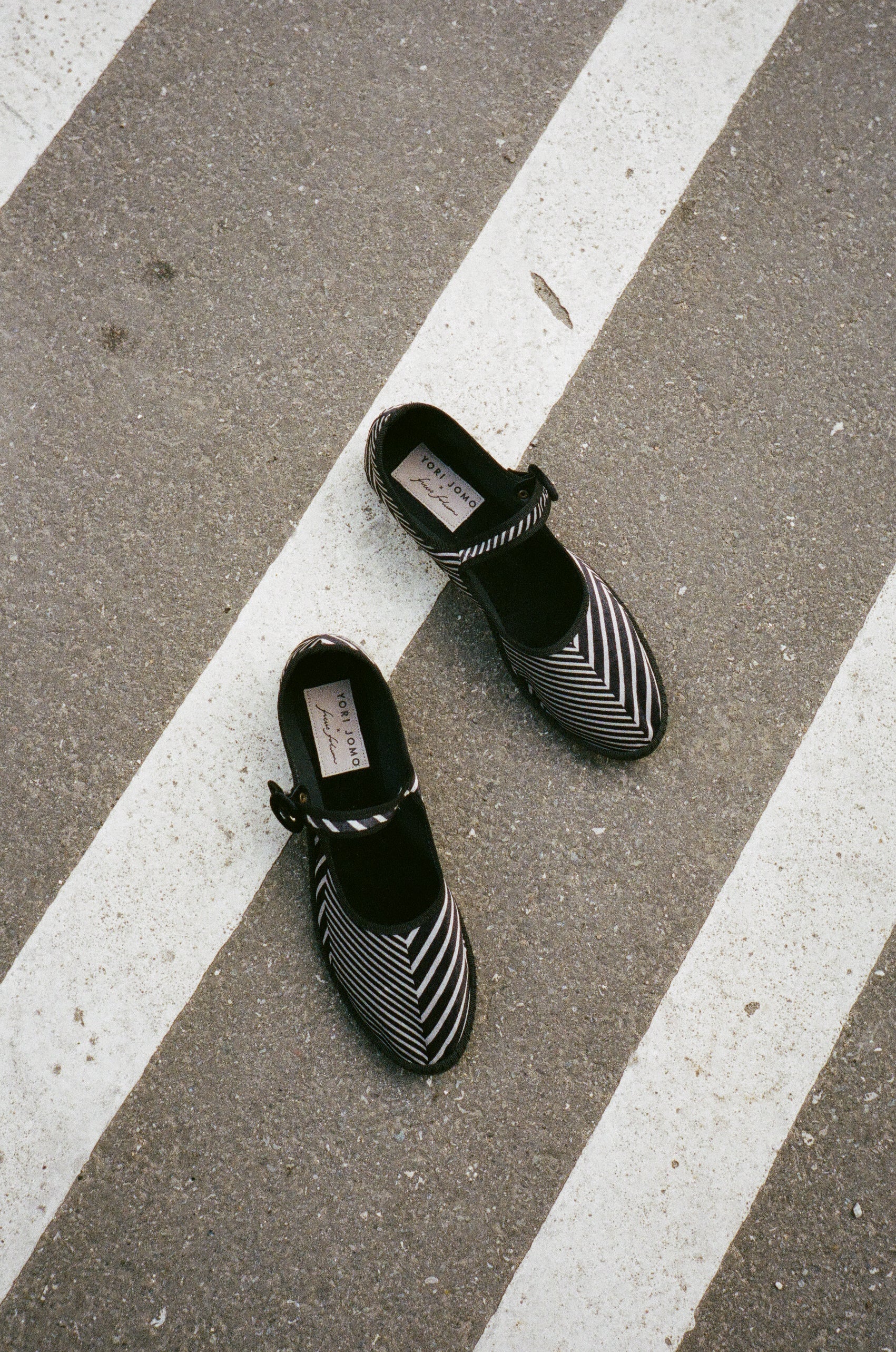 Limited edition Mary Janes made in collaboration with Ficus Folium.  A take on a modern ballerina mixed with the classic features of a mary jane. The shoes have a flat sole with a small heel, a buckle closure over the foot, and a closed rounded toe.  The shoes are handmade in Italy using traditional production techniques in carefully selected high-quality materials.  Color: Black and grey zig-zag pattern  Material: 100% silk velour Sole: 100% rubber sole